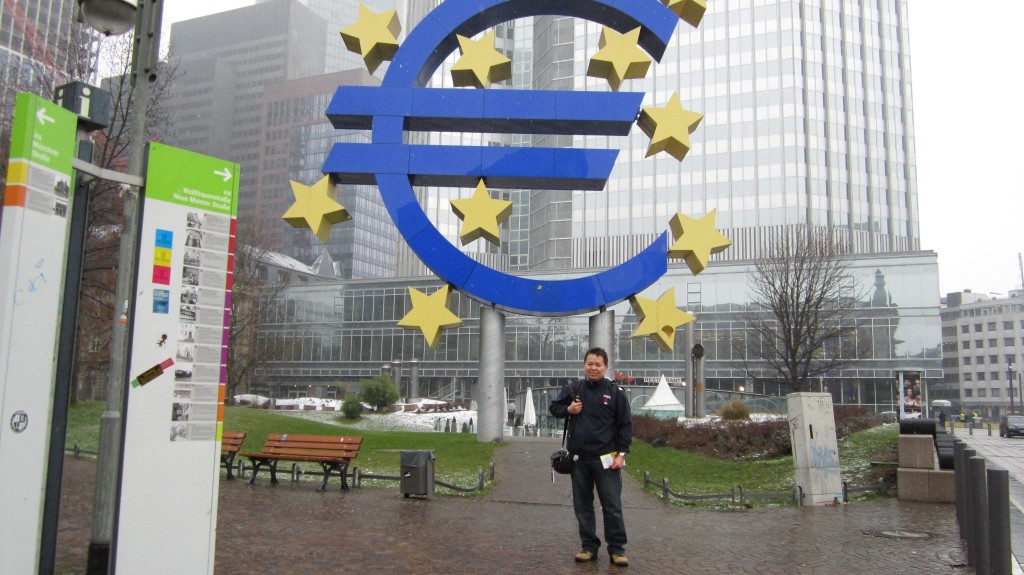 Charles Huang during stopover in Frankfurt.  Photo taken in front of the European Central Bank.