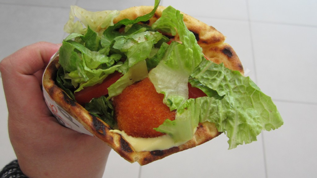 Greek Gyros, a popular street food consist of roasted meat on a vertical spit and usually served in a pita