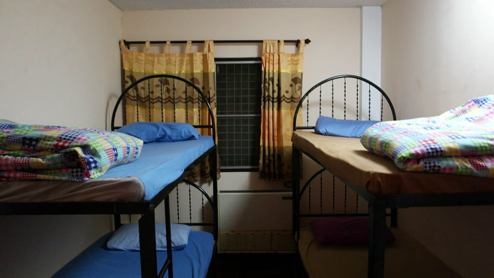 Dorm bedroom are fan and air conditioned, fresh linens are included and access to shared bathroom