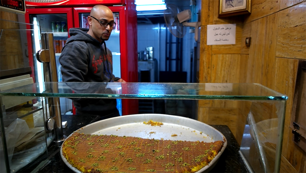 Dahdah, popular dessert which is sold on the streets produced with semolina set into yellow layers and with a brown layer inside